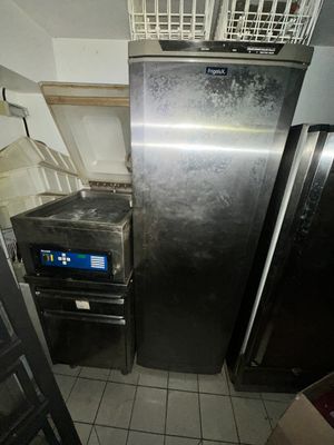 a refrigerator and a dishwasher in a small kitchen