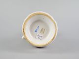 a close up of a cup on a table with a white background