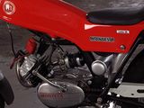 a red motorcycle that is parked in a garage