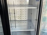 an open refrigerator that is sitting inside of a building