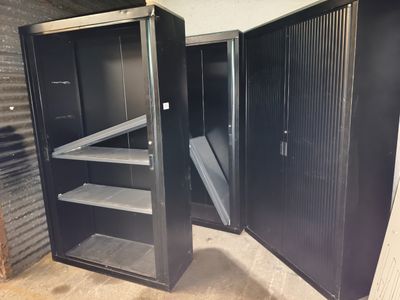 two open metal cabinets in a storage room