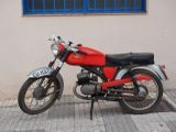 a red and black motorcycle parked on the side of the street