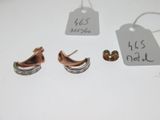 two pairs of earrings and a price tag on a table