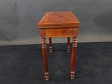 a small wooden table with a drawer on top of it