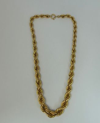 a gold chain necklace with a knot design on a white background