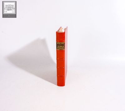 a red book with a pencil sticking out of it