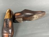 pair of men ' s brown leather shoes with laces on them