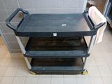 an image of a black utility cart in a public restroom