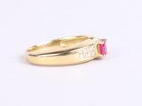 a close up of a gold ring with a pink stone and diamonds