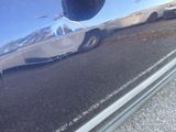a close up of a car ' s door handle on the side of the road