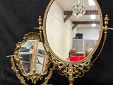 a mirror and a mirror stand with a chandelier in the background