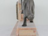 a statue of a dog that is standing on a wooden platform