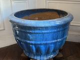 a large blue pot sitting on a wooden floor