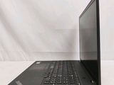 the back of a laptop computer sitting on top of a white table