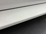 a close up of a car ' s front bumper with scratches on it