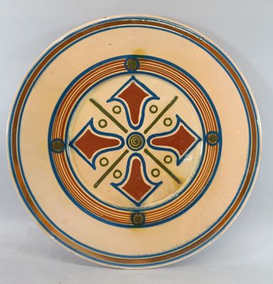 a plate with a design on it on a white surface