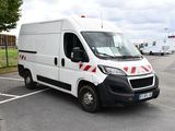 a white van that is parked in a parking lot