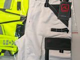 a yellow vest and a pair of white pants in a bag