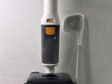a black and white vacuum with a cord attached to it