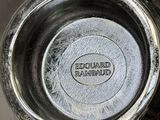 a close up of a metal bowl with a logo on it