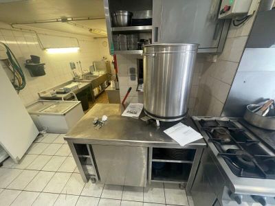 une cuisine équipée d'une cuisinière, d'un évier et d'un réfrigérateur