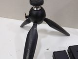 a small tripod sitting on a table next to a cell phone