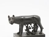 a statue of a dog and a cat on a table