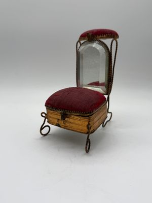 an old wooden chair with a mirror on top of it
