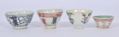 three cups with designs on them are sitting next to each other