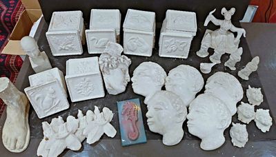 a lot of white ceramic figurines sitting on a table