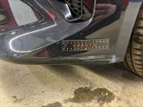 a close up of a car ' s bumper with a sticker on it