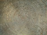 a large metal bowl with a design on it