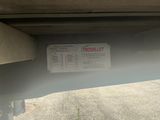 a sign on the back of a car that is parked in a parking lot