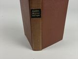 un vieux livre à la couverture marron posé sur une table blanche