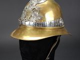 a close up of a gold helmet on a mannequin head