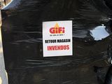 a pile of black garbage bags with a sign on it