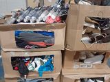 several boxes of shoes are stacked on top of each other in a warehouse