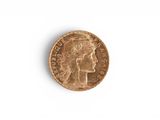 a close up of a gold coin with a woman ' s head on it