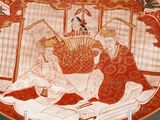 a plate with a painting of a woman and a man sitting on a bed