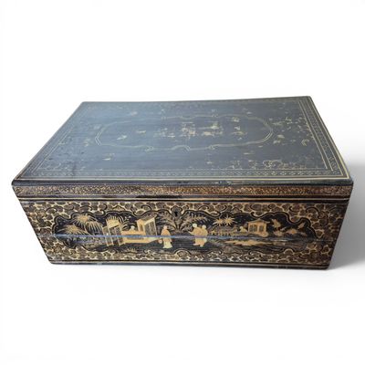 a black and gold box with a train design on it