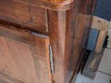 a wooden cabinet with a door on top of it