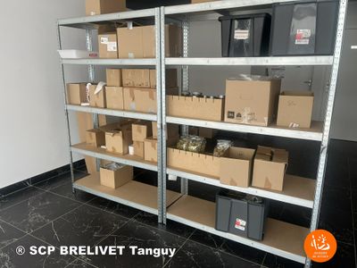 many boxes and boxes on the shelves in the room