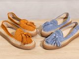 a pair of blue and orange sued shoes with tassels on them
