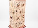 a tall wooden cabinet with a bird design on it