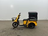 an image of a yellow scooter with a box on the back