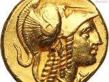 a close up of a gold coin with a head of a man