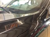 a black car with a sticker on the side of it