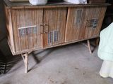 a wooden cabinet with two baskets on top of it