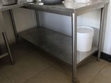 a stainless steel table with a bucket on top of it