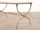 an image of a table with a glass top on a concrete floor
